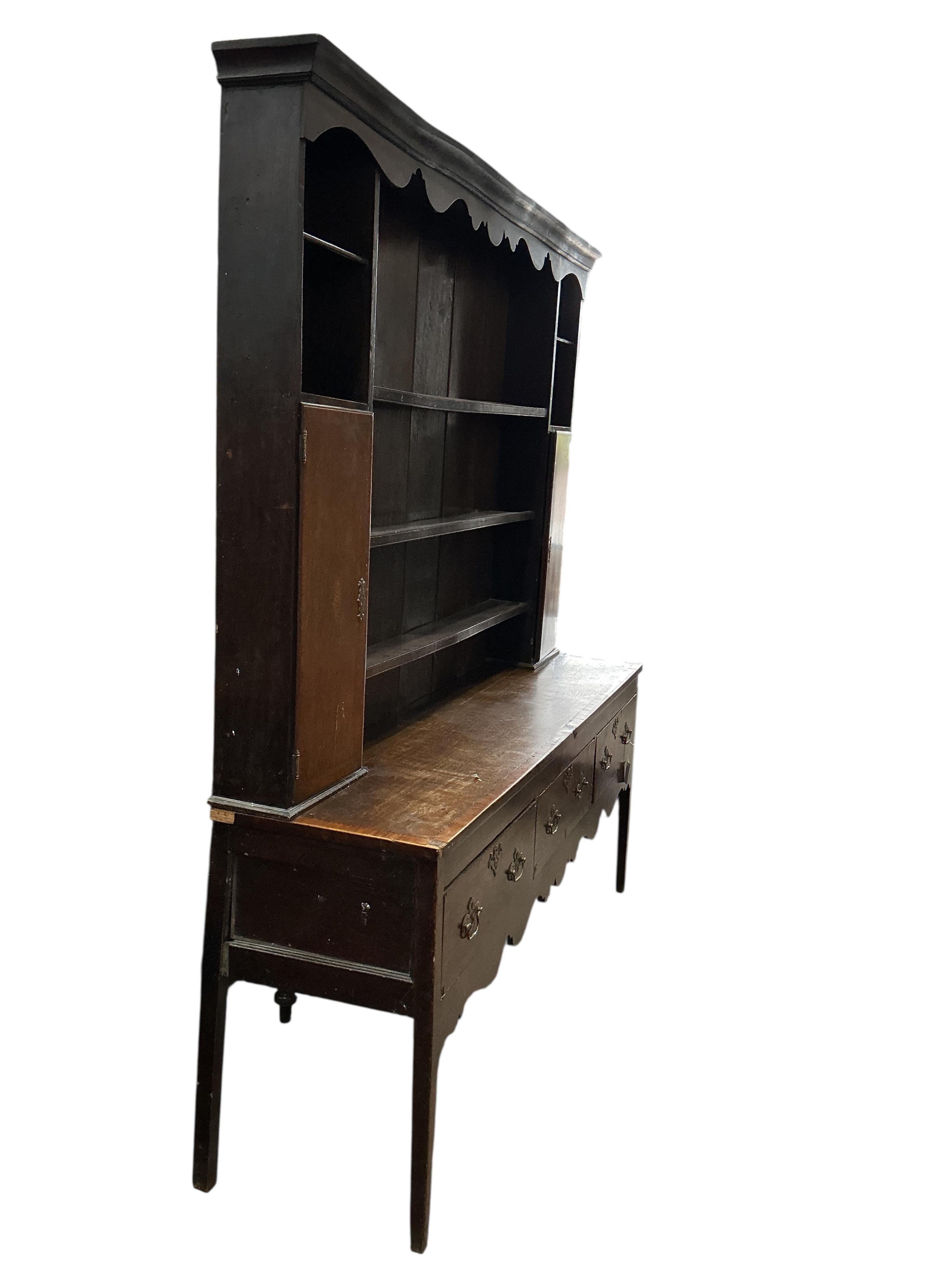 A George III banded mahogany dresser with boarded rack, width 185cm, depth 48cm, height 212cm